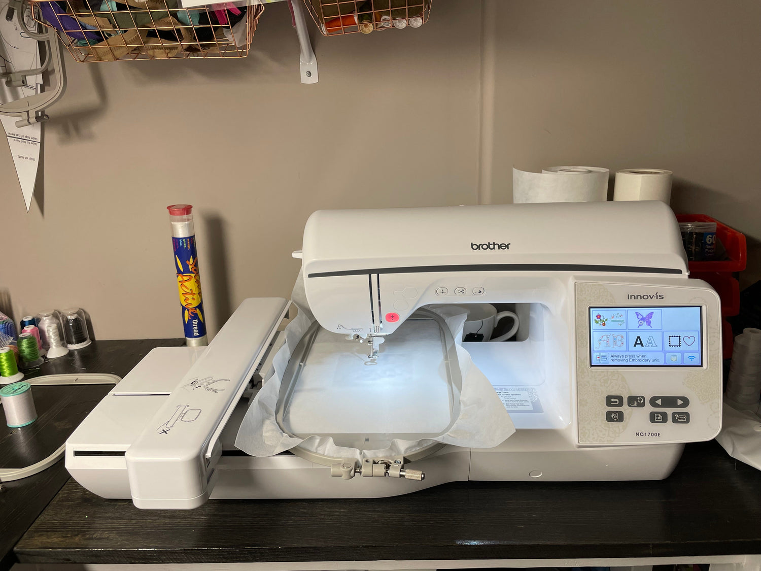Home embroidery machine stitching a custom service dog patch using stabilizer, shown mid-process in a small business workspace.